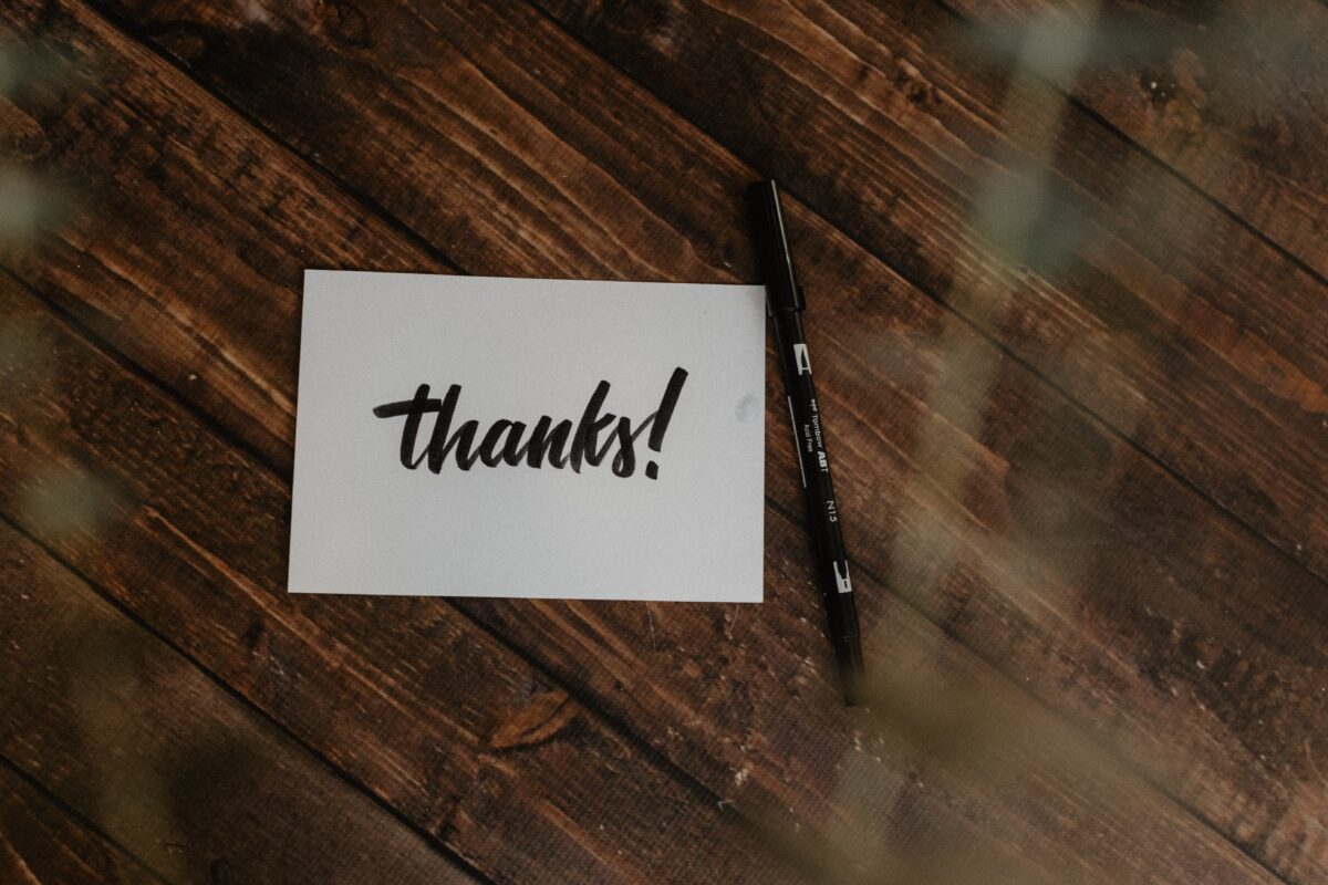 Thank you cards for teachers. Card says "thanks!" in black print and is placed next to a black pen.