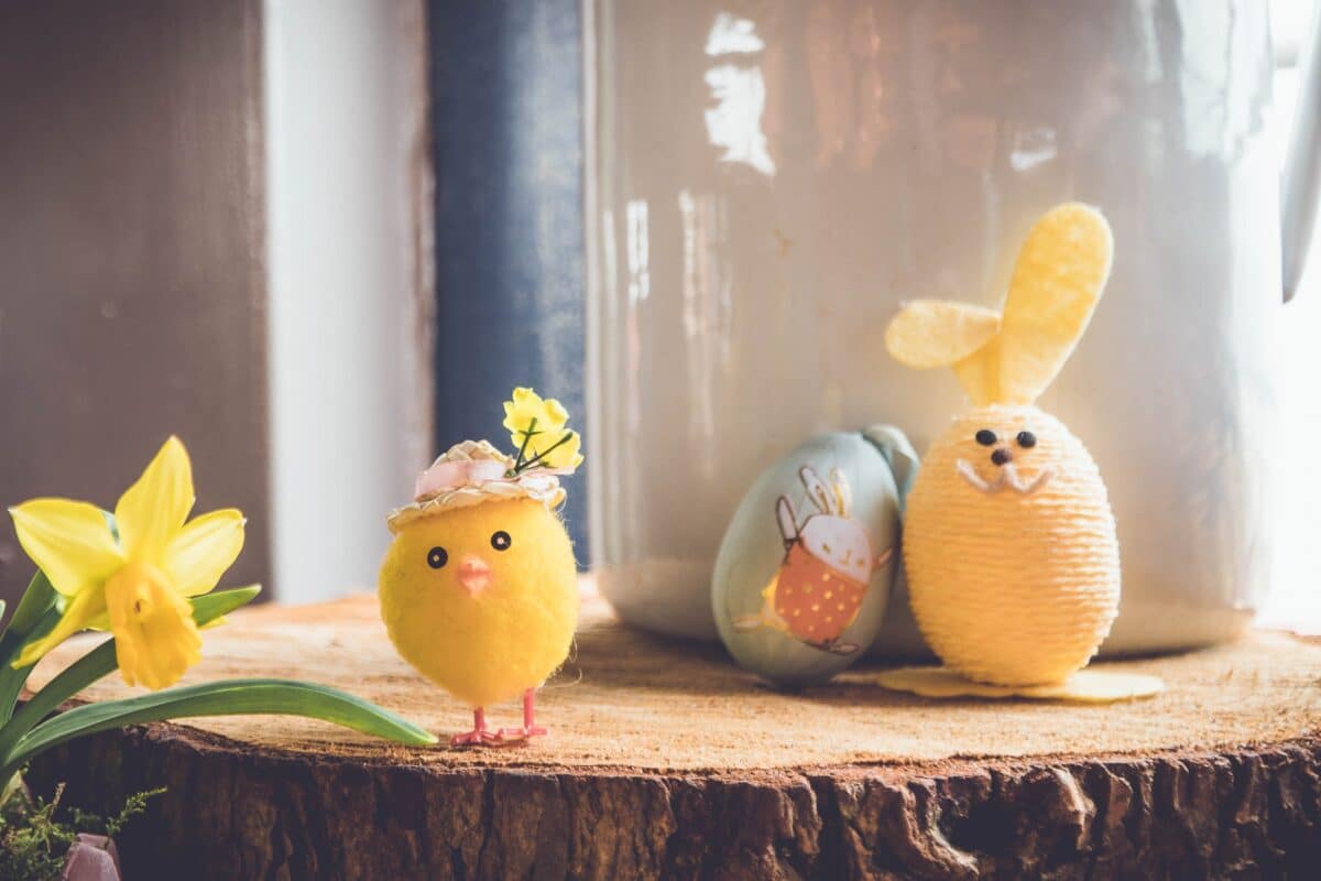 Cute Easter toy chick, bunny, and eggs displayed on a wooden surface