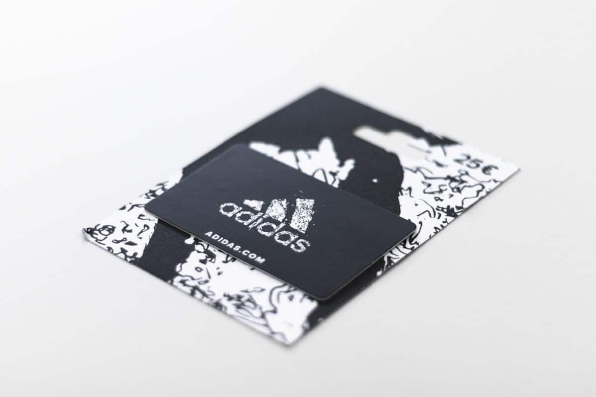 Black and white Adidas gift card on a flat surface